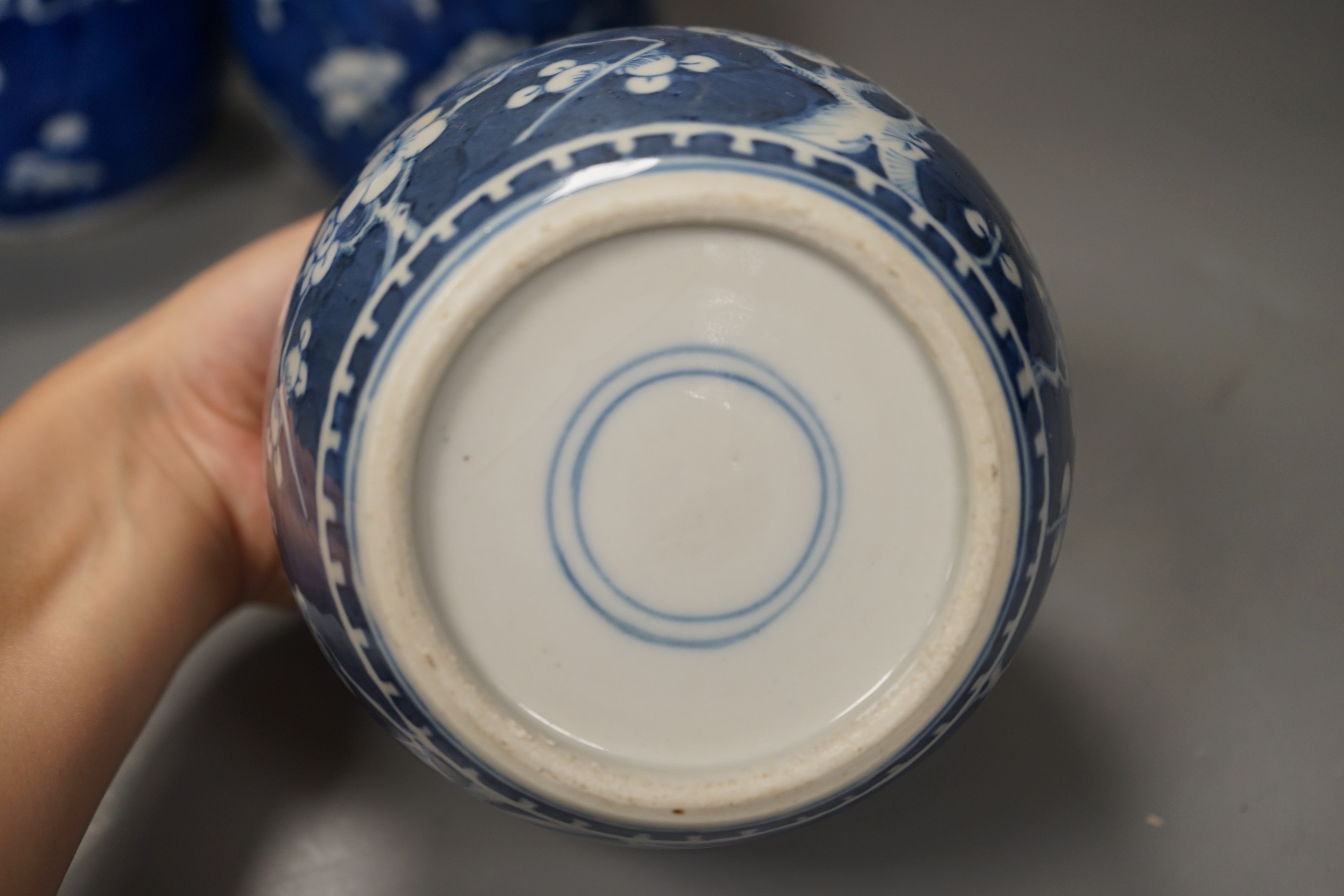 Three 19th century Chinese blue and white 'prunus' jars and two covers, 15cm